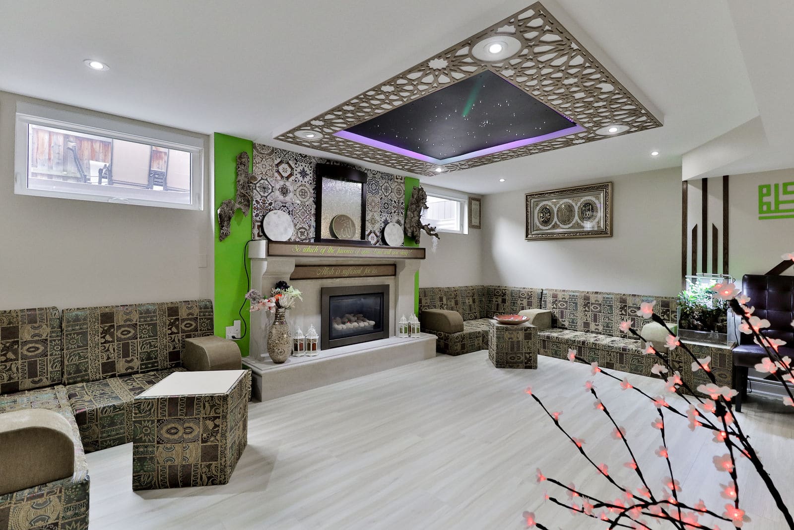 The fireplace wall and majlis seating under the star ceiling