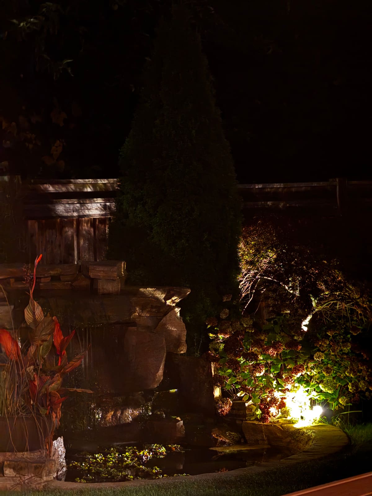 The rock waterfall lit at night