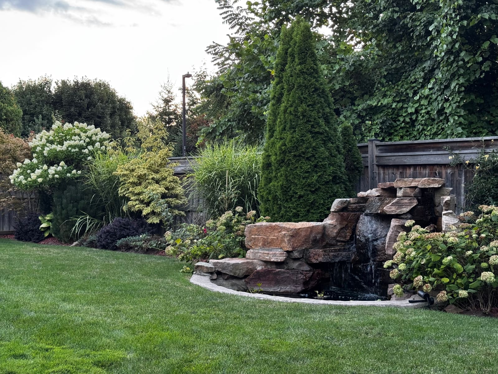 The backyard rock waterfall during the day
